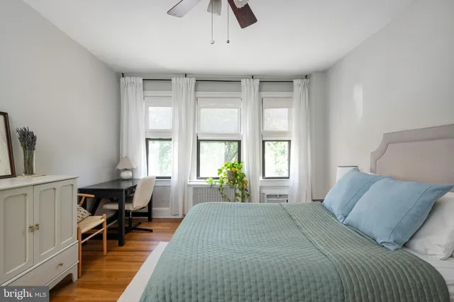 a bed room with a bed and a chair