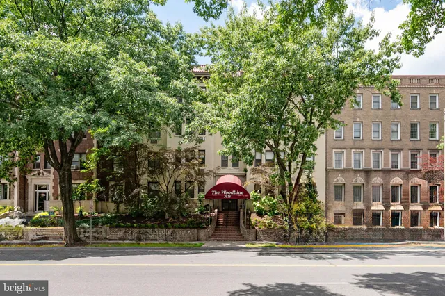 a view of a brick building next to a road