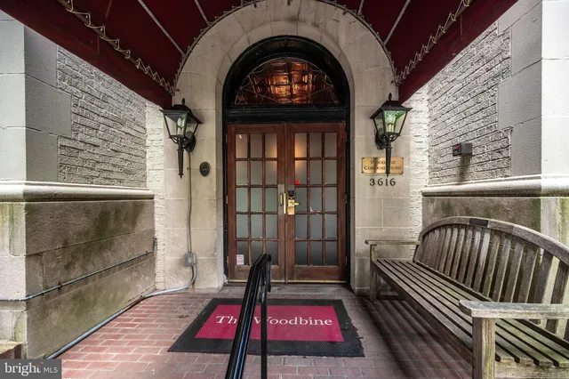 a street sign on a sidewalk next to a road