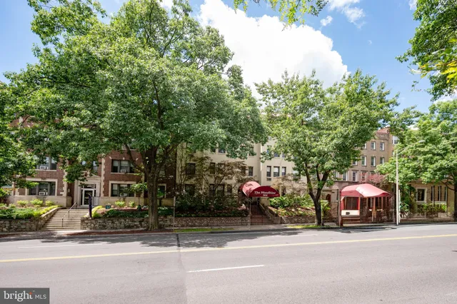 a view of a brick building next to a road