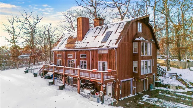 a view of a house with a yard covered in snow