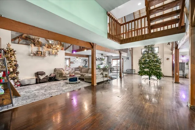 a dining hall with stainless steel appliances granite countertop lots of wooden furniture