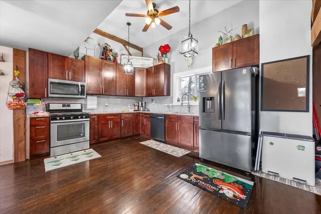 a kitchen with stainless steel appliances granite countertop a sink and cabinets