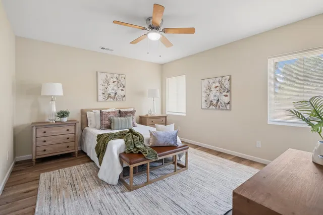 a living room with furniture and a view of kitchen