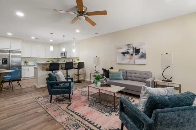 a living room with furniture and a wooden floor