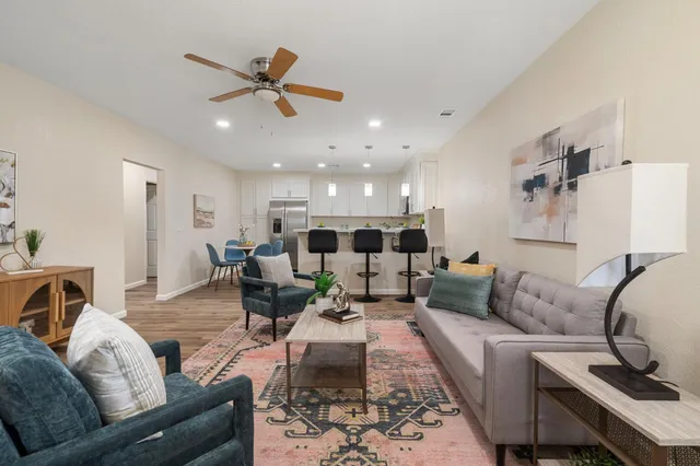 a kitchen with kitchen island a dining table and chairs
