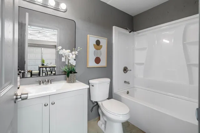 a front view of a house with a yard and mountain view