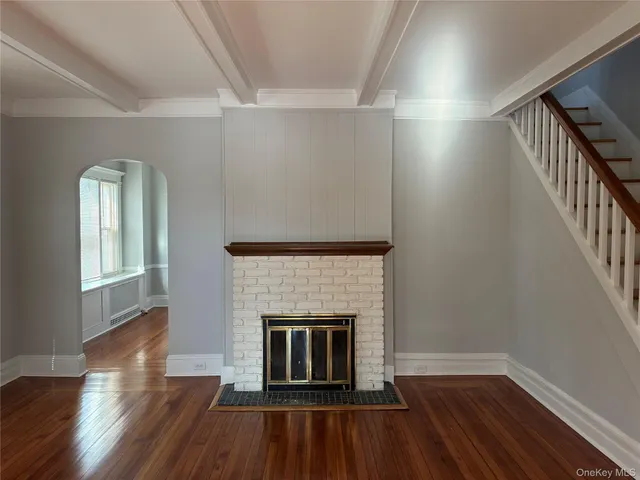 wooden floor fireplace and natural light in room