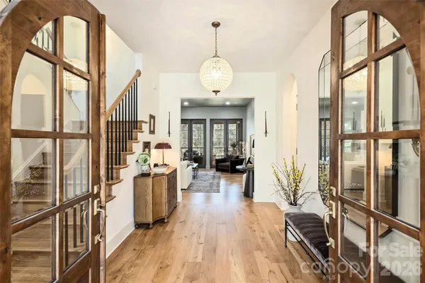 a very nice looking room with wooden floor and furniture