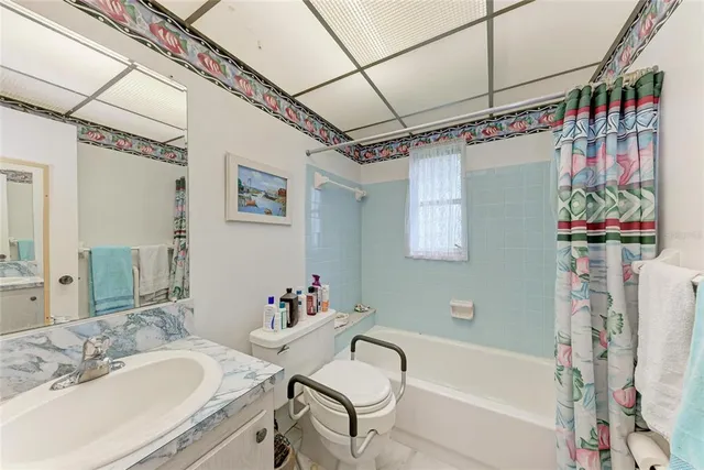 a bath room with a sink and a bath tub