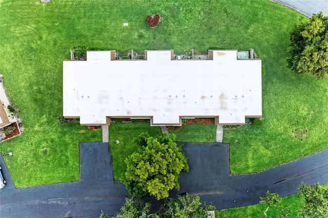 an aerial view of a house with yard and outdoor seating