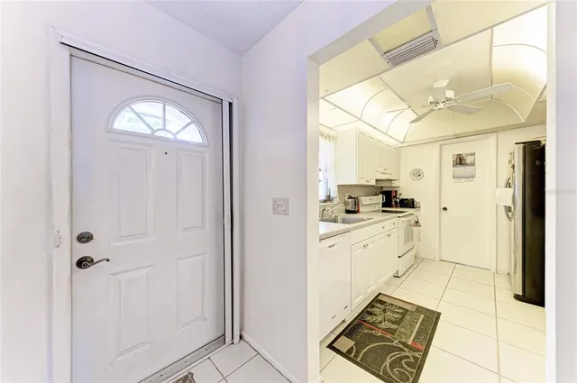 a kitchen with white cabinets and appliances