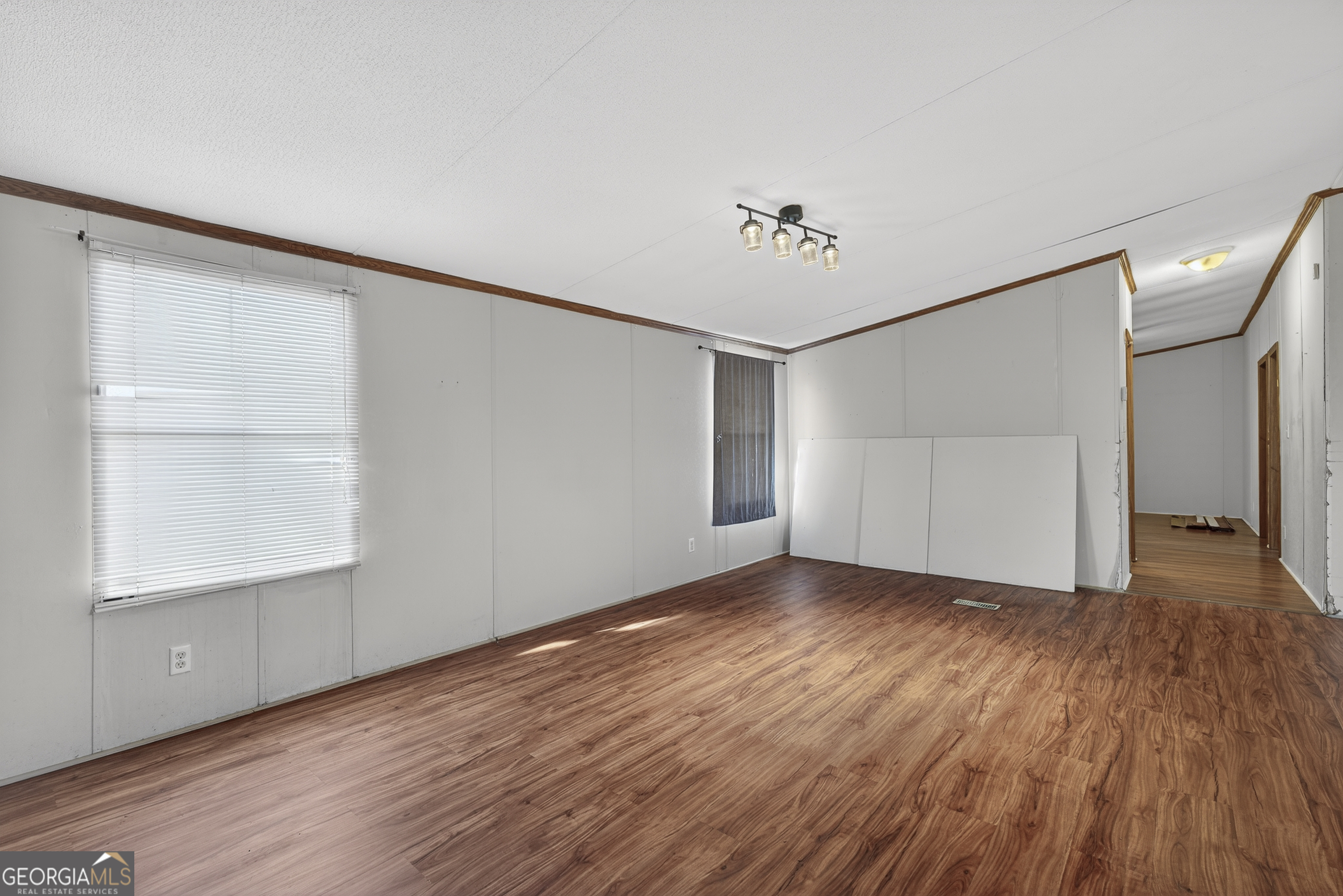 157 Linstead Drive Macon, GA 31216 - Photo 13 of 42 a view of an empty room with wooden floor and a window