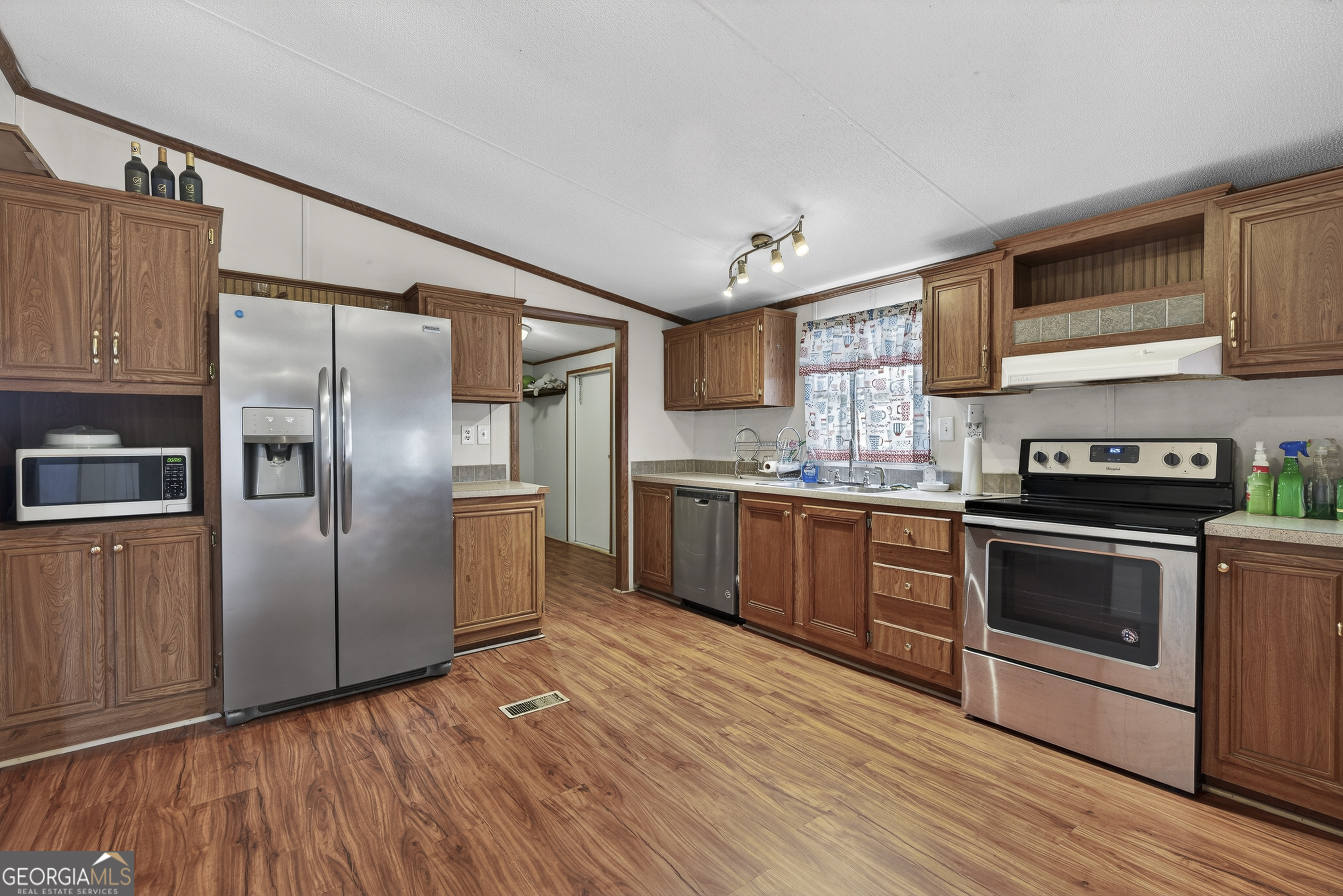 157 Linstead Drive Macon, GA 31216 - Photo 18 of 42 a kitchen with stainless steel appliances granite countertop a refrigerator a sink dishwasher a stove with wooden floors