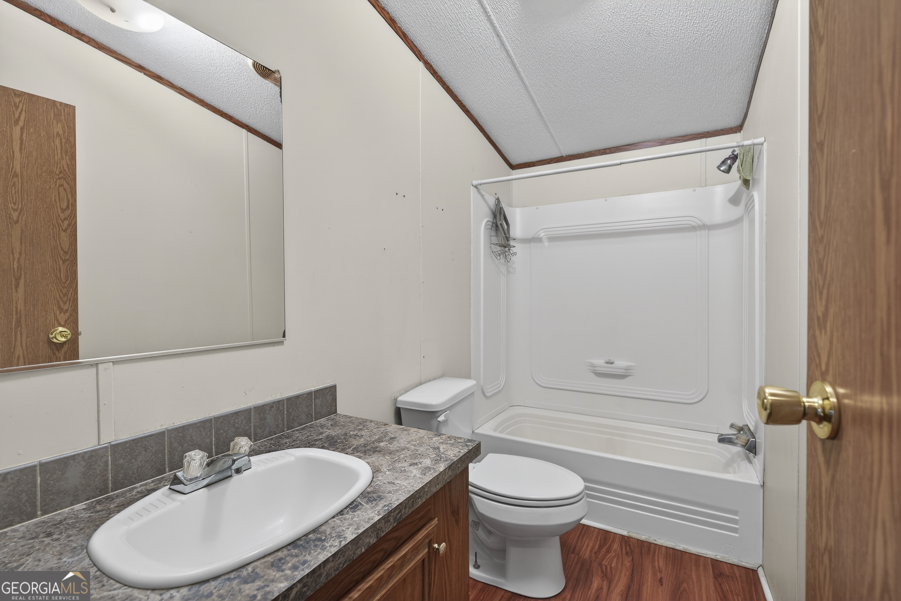 157 Linstead Drive Macon, GA 31216 - Photo 22 of 42 a bathroom with a granite countertop toilet sink and mirror
