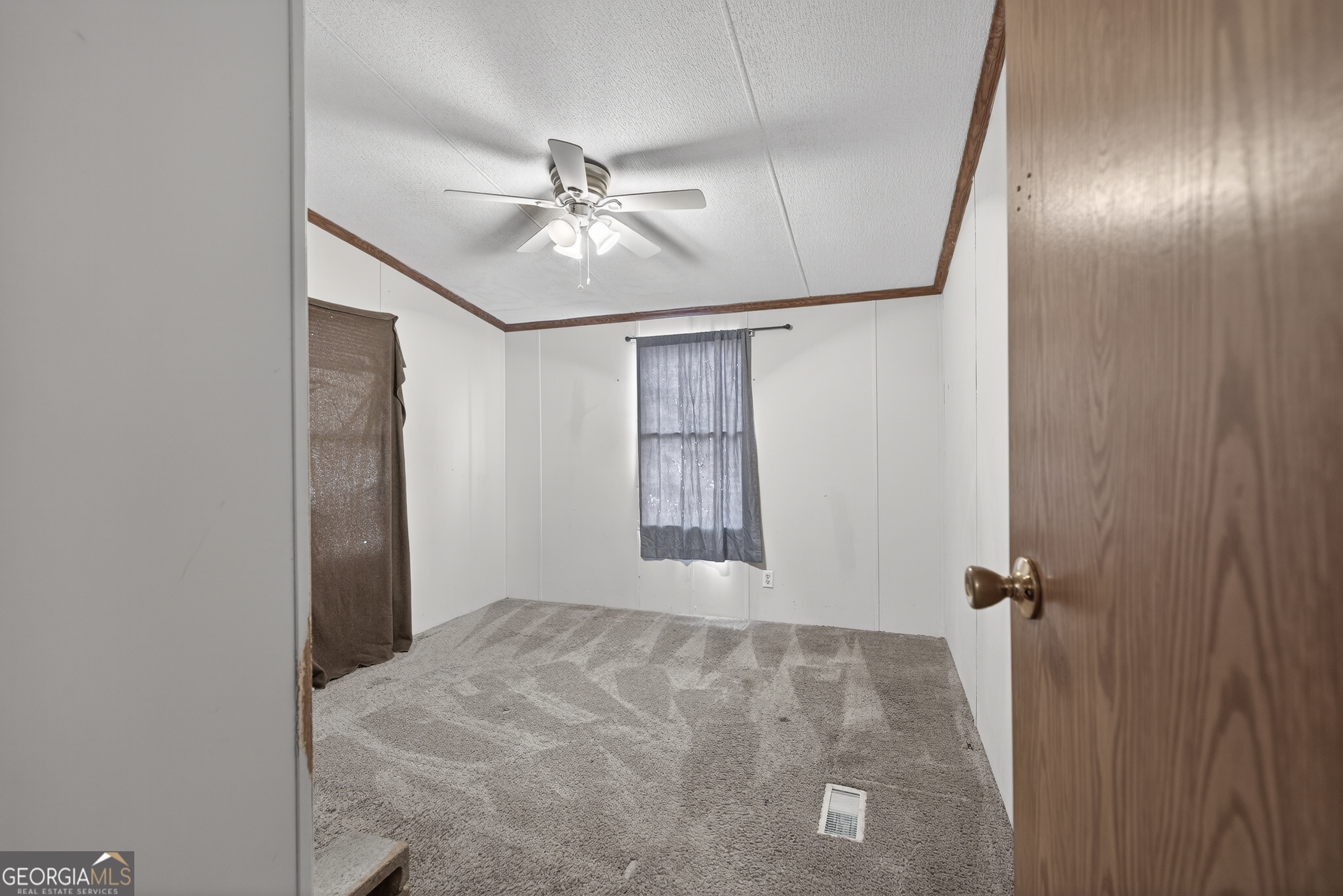 157 Linstead Drive Macon, GA 31216 - Photo 25 of 42 an empty room with windows and fan