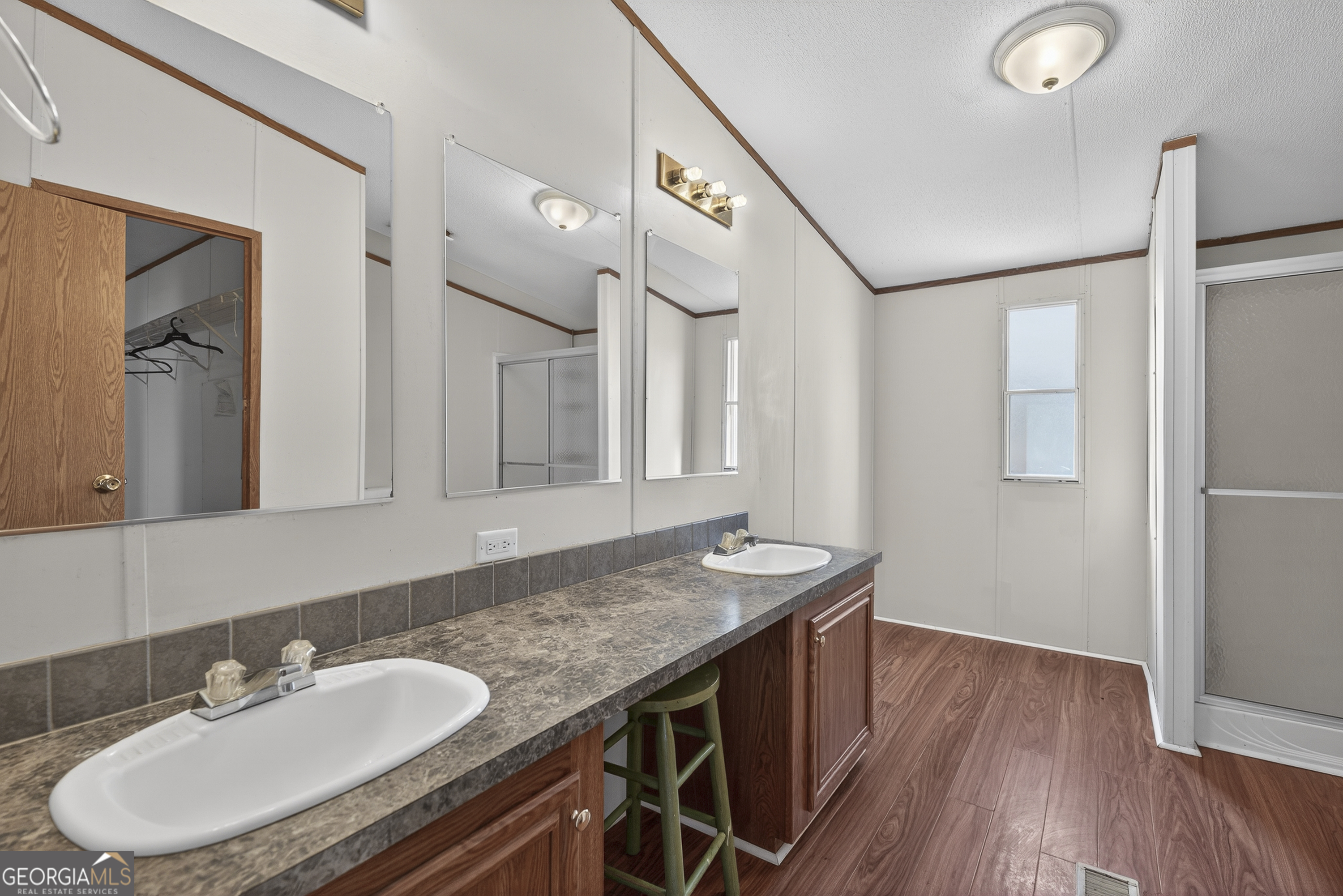 157 Linstead Drive Macon, GA 31216 - Photo 31 of 42 a bathroom with a granite countertop sink a mirror and a shower