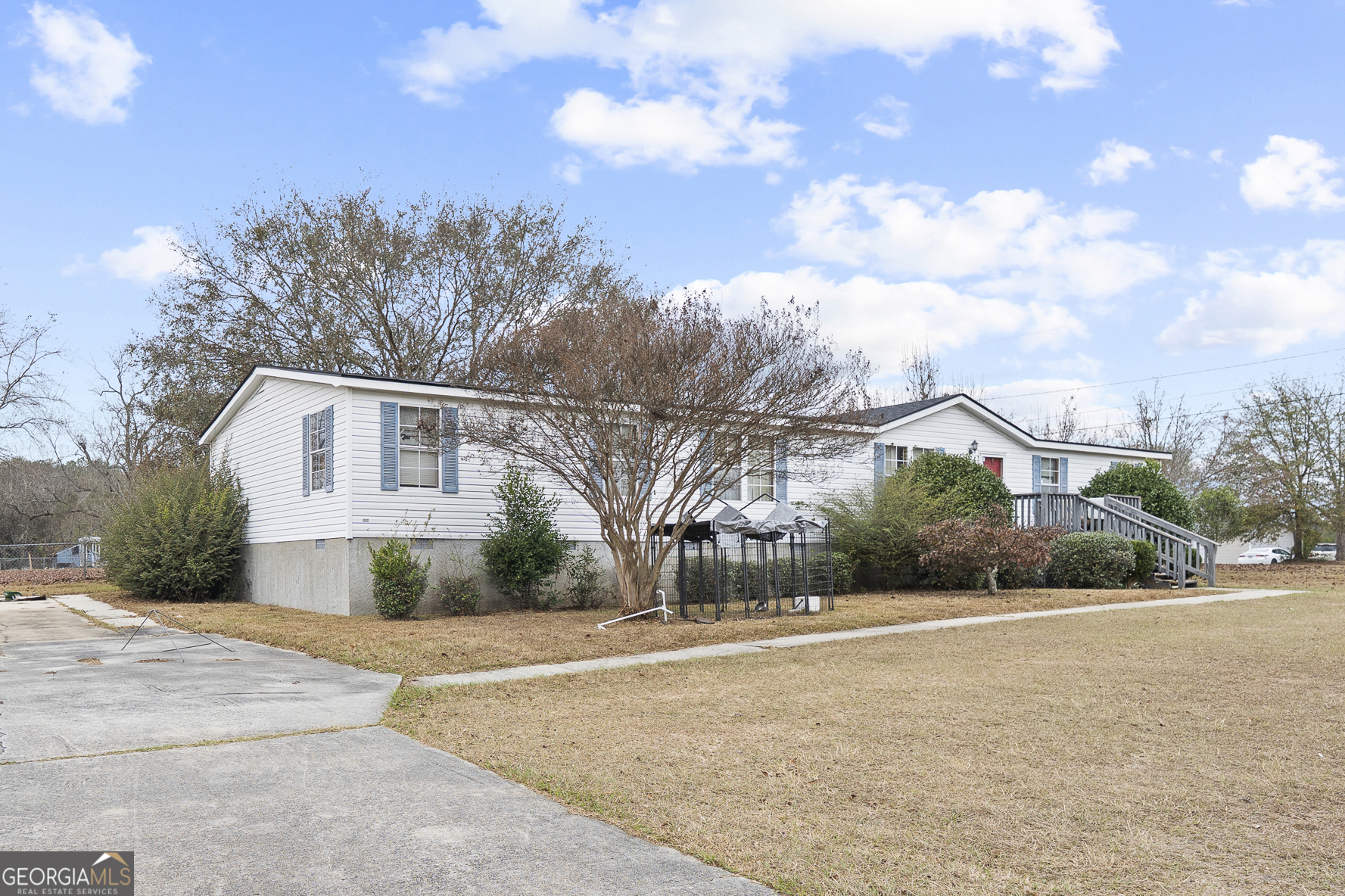 157 Linstead Drive Macon, GA 31216 - Photo 4 of 42 a view of a white house with a big yard and large trees