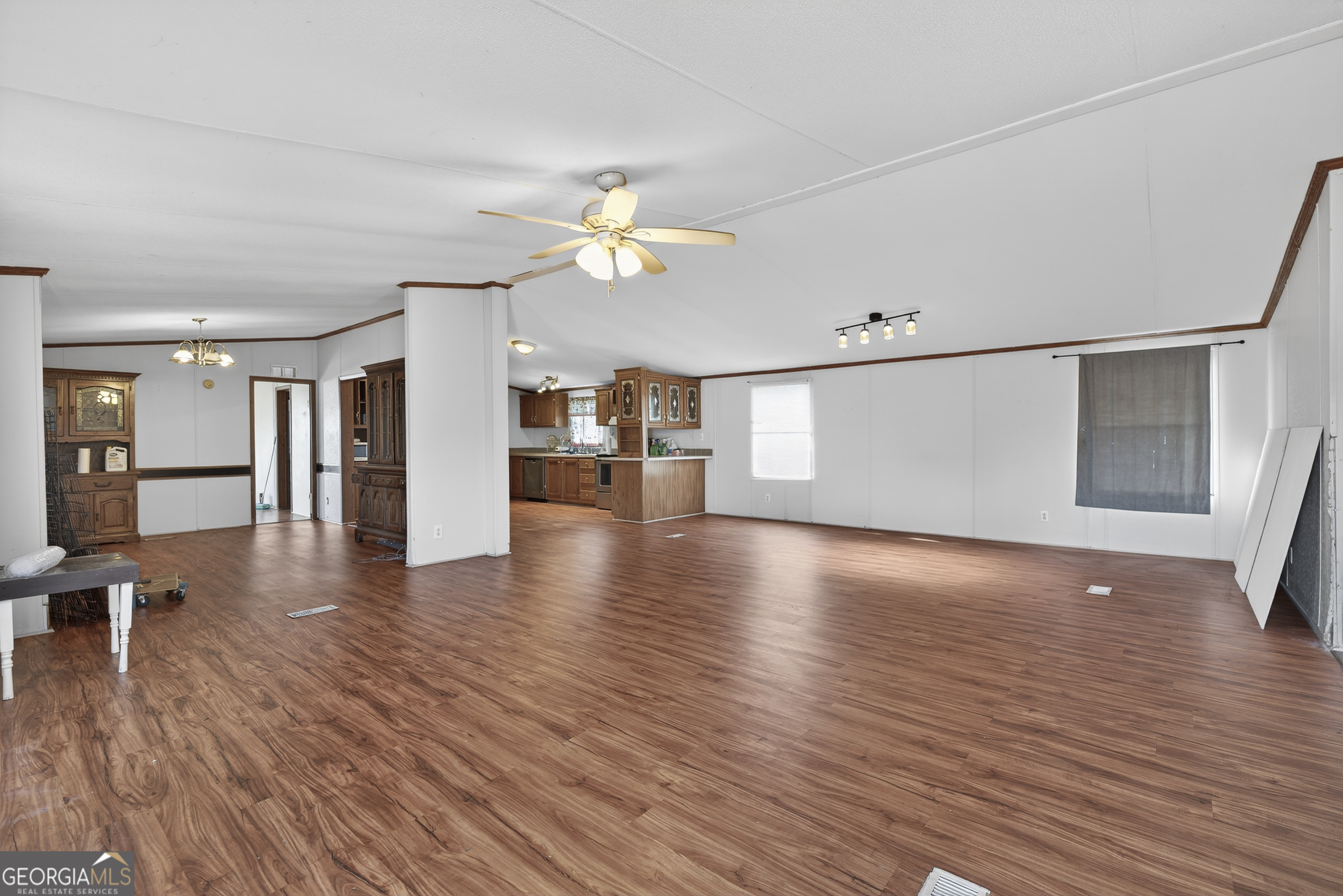157 Linstead Drive Macon, GA 31216 - Photo 7 of 42 a view of an empty room with wooden floor and a kitchen