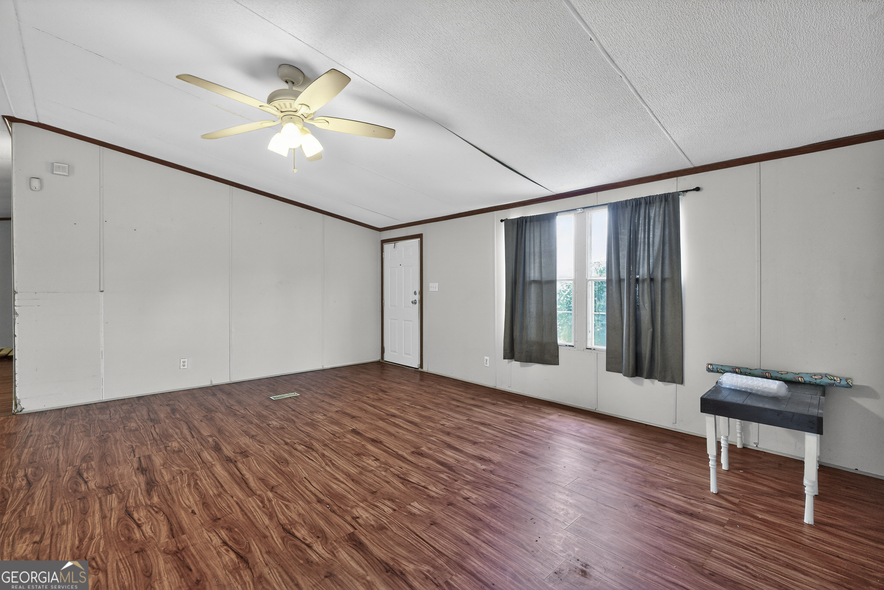 157 Linstead Drive Macon, GA 31216 - Photo 8 of 42 a view of an empty room with wooden floor and a ceiling fan