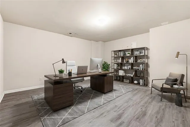 a view of a workspace with furniture and wooden floor