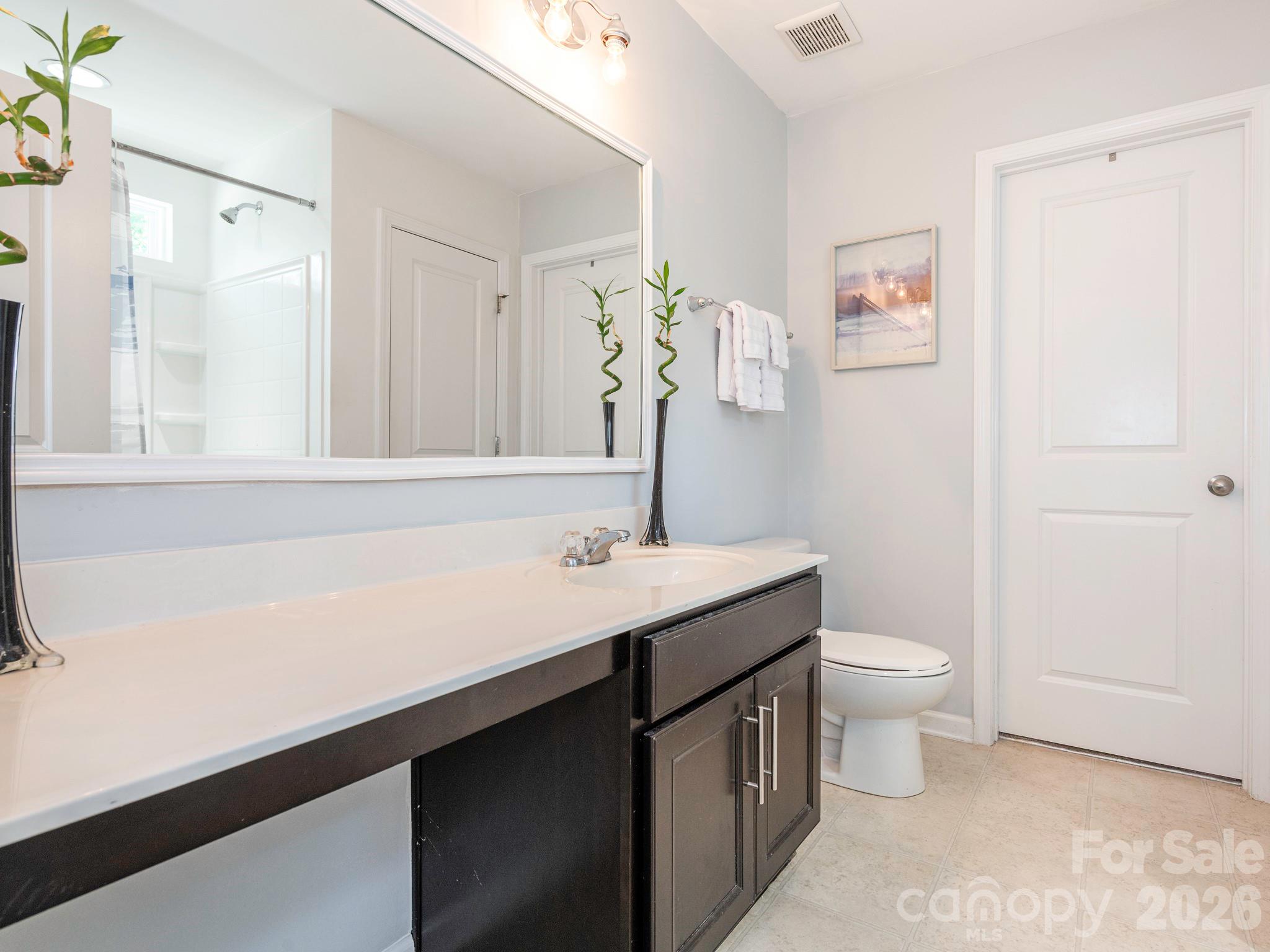 1354 Soothing Court Northwest Concord, NC 28027 - Photo 14 of 22 a bathroom with a sink a toilet and a mirror