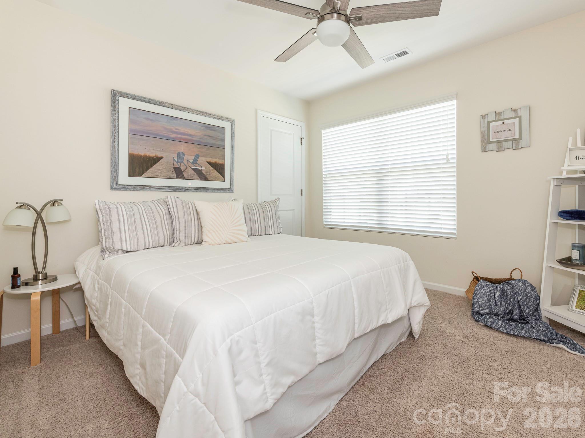 1354 Soothing Court Northwest Concord, NC 28027 - Photo 19 of 22 a bedroom with a bed and a painting on the wall