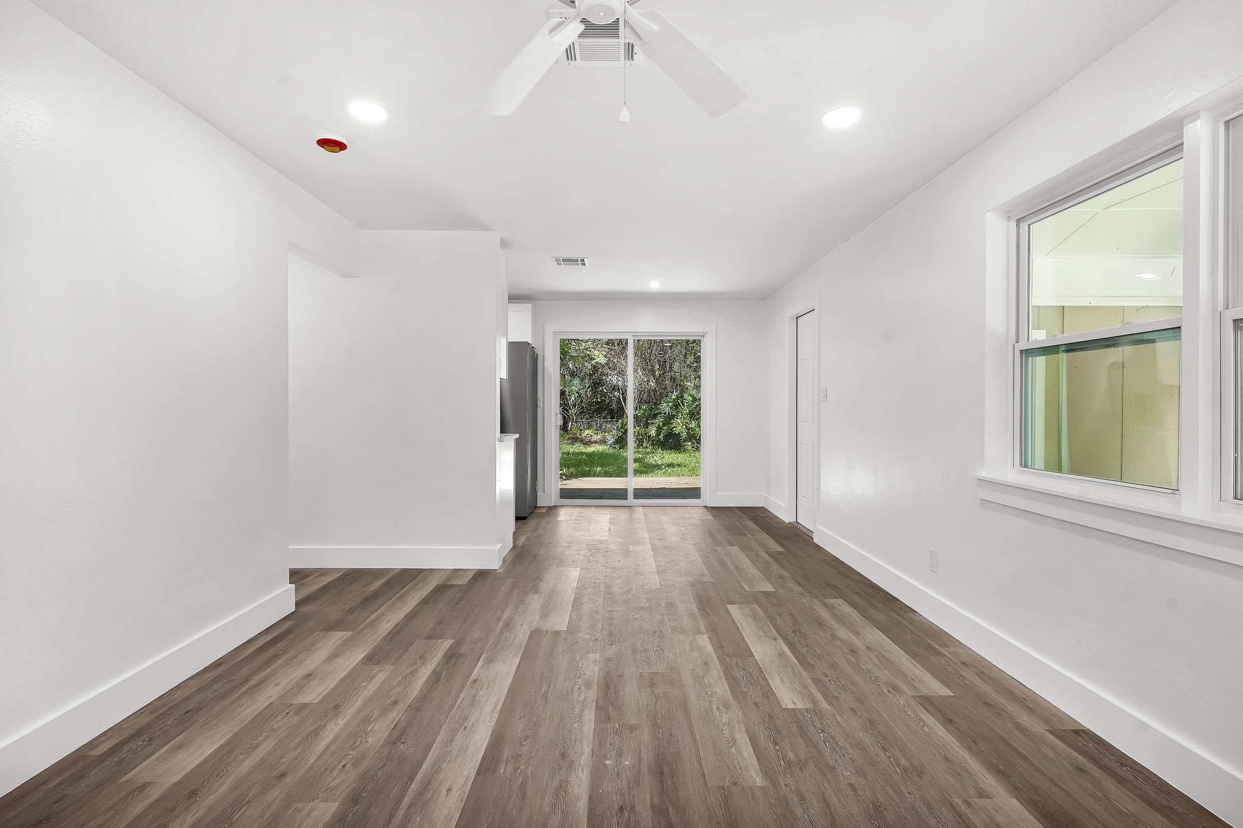 13 Oak Street St. Augustine, FL 32084 - Photo 15 of 39 wooden floor in an empty room with a window