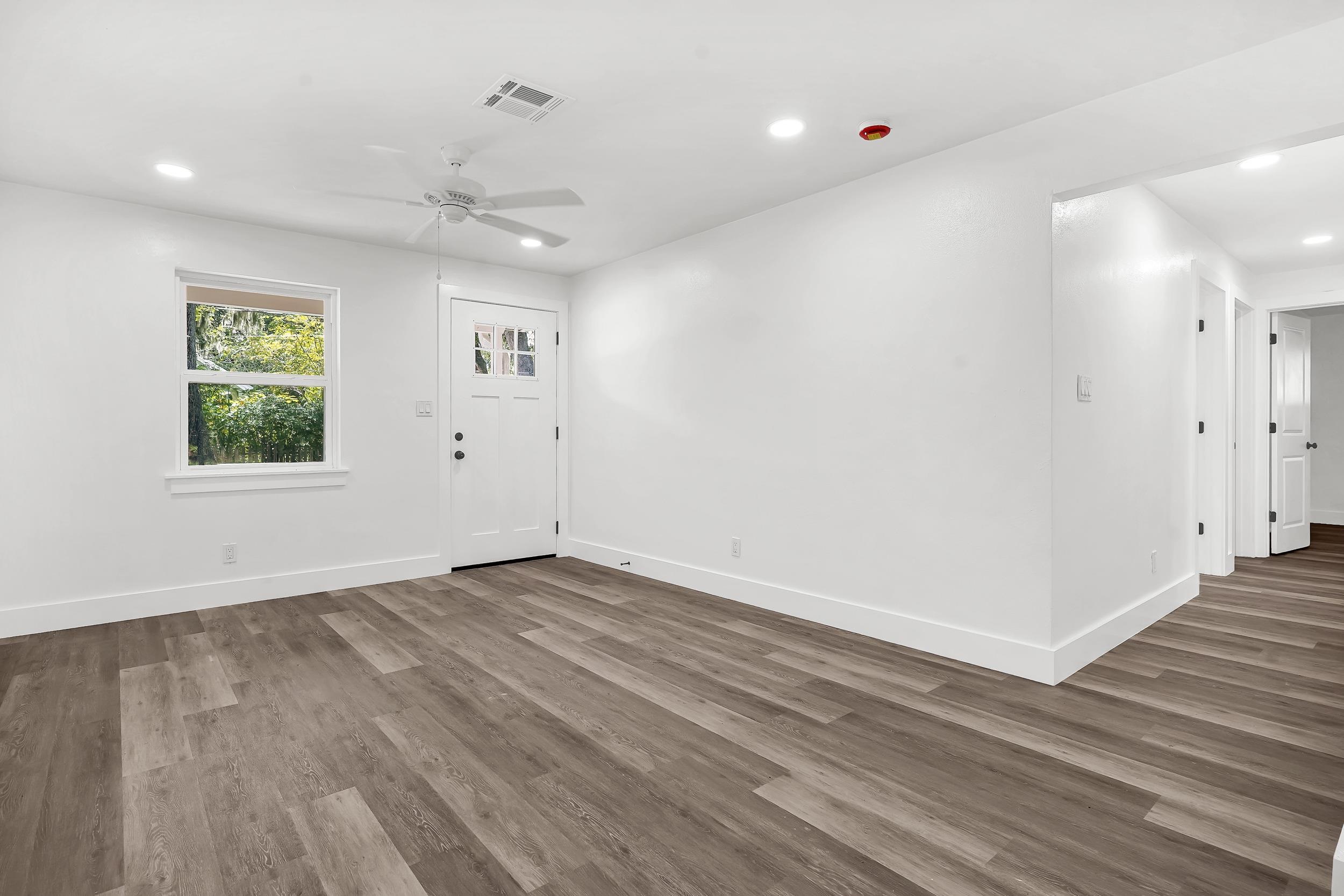 13 Oak Street St. Augustine, FL 32084 - Photo 18 of 39 wooden floor in an empty room with a window