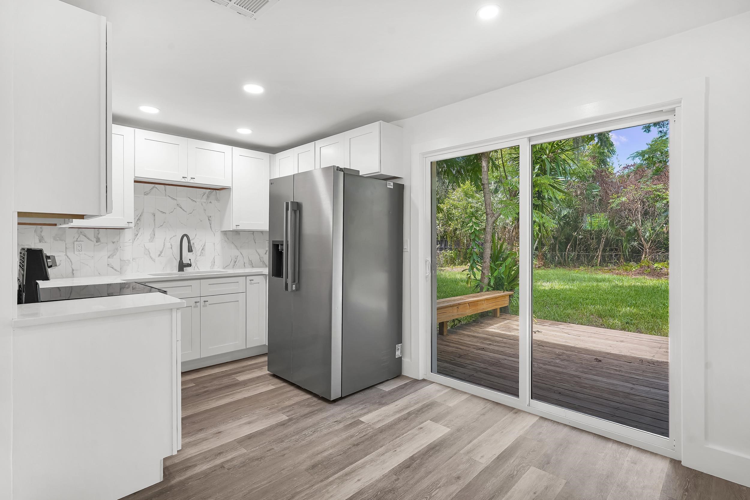 13 Oak Street St. Augustine, FL 32084 - Photo 19 of 39 a kitchen with refrigerator and window
