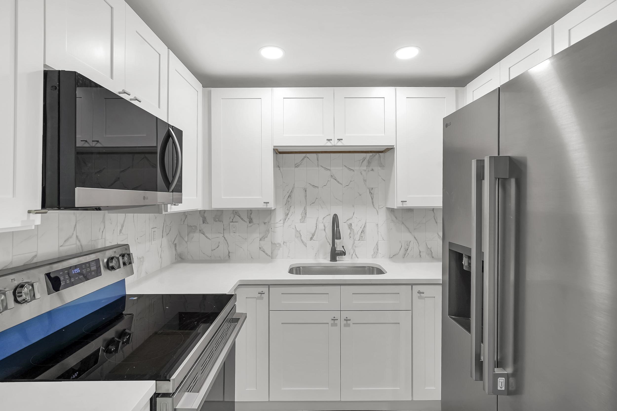 13 Oak Street St. Augustine, FL 32084 - Photo 21 of 39 a kitchen with stainless steel appliances a refrigerator stove and microwave