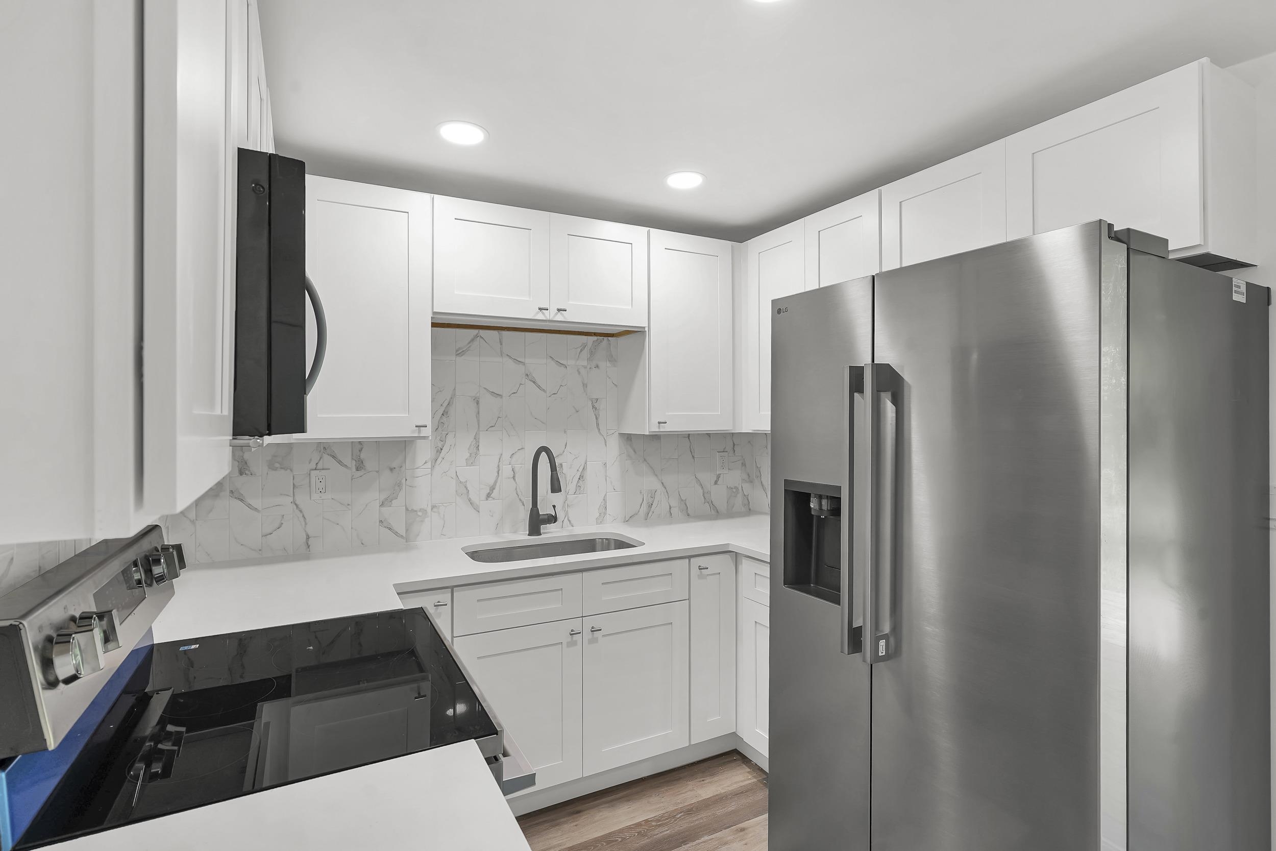 13 Oak Street St. Augustine, FL 32084 - Photo 22 of 39 a kitchen with a refrigerator sink and cabinets