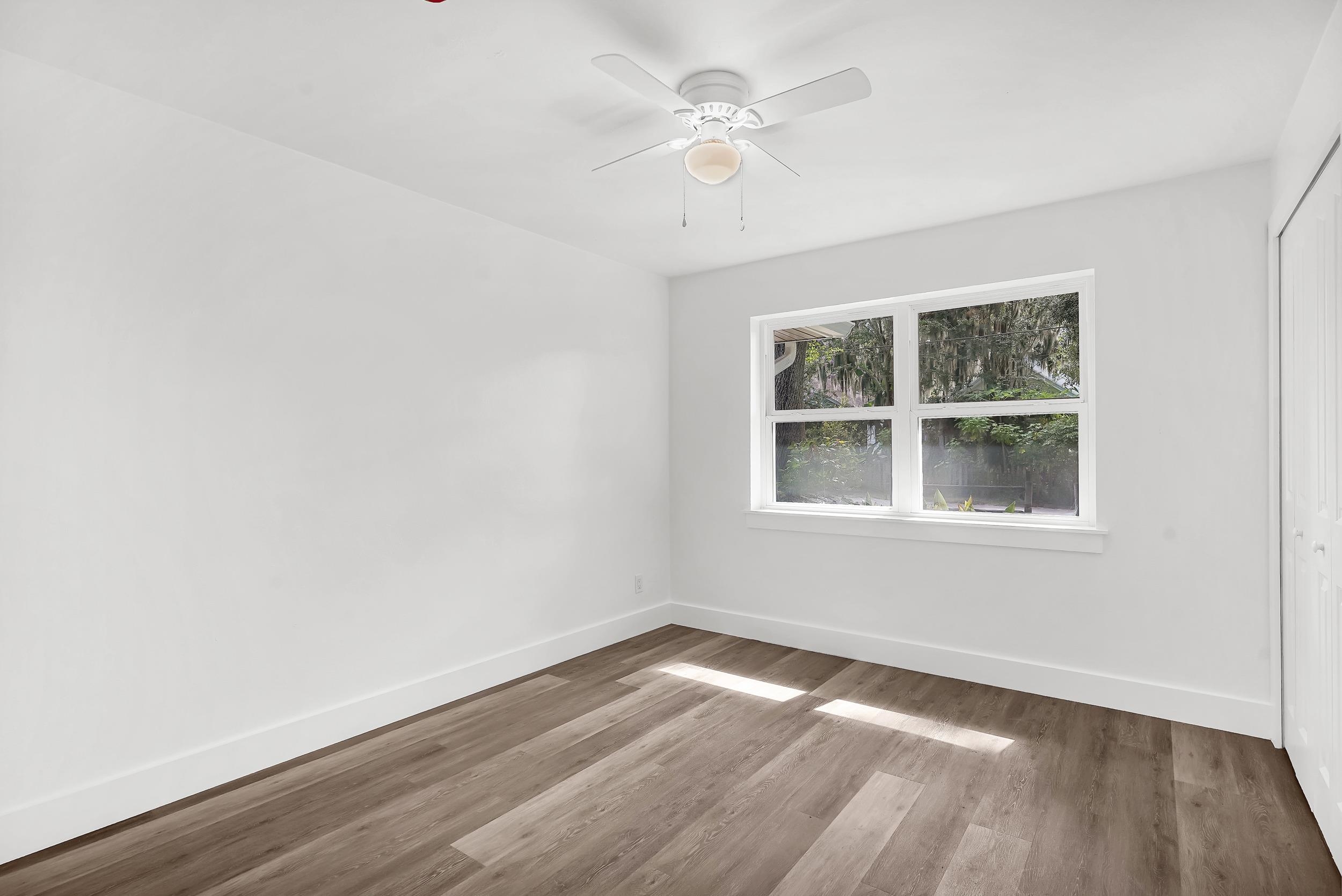 13 Oak Street St. Augustine, FL 32084 - Photo 27 of 39 an empty room with a window and wooden floor