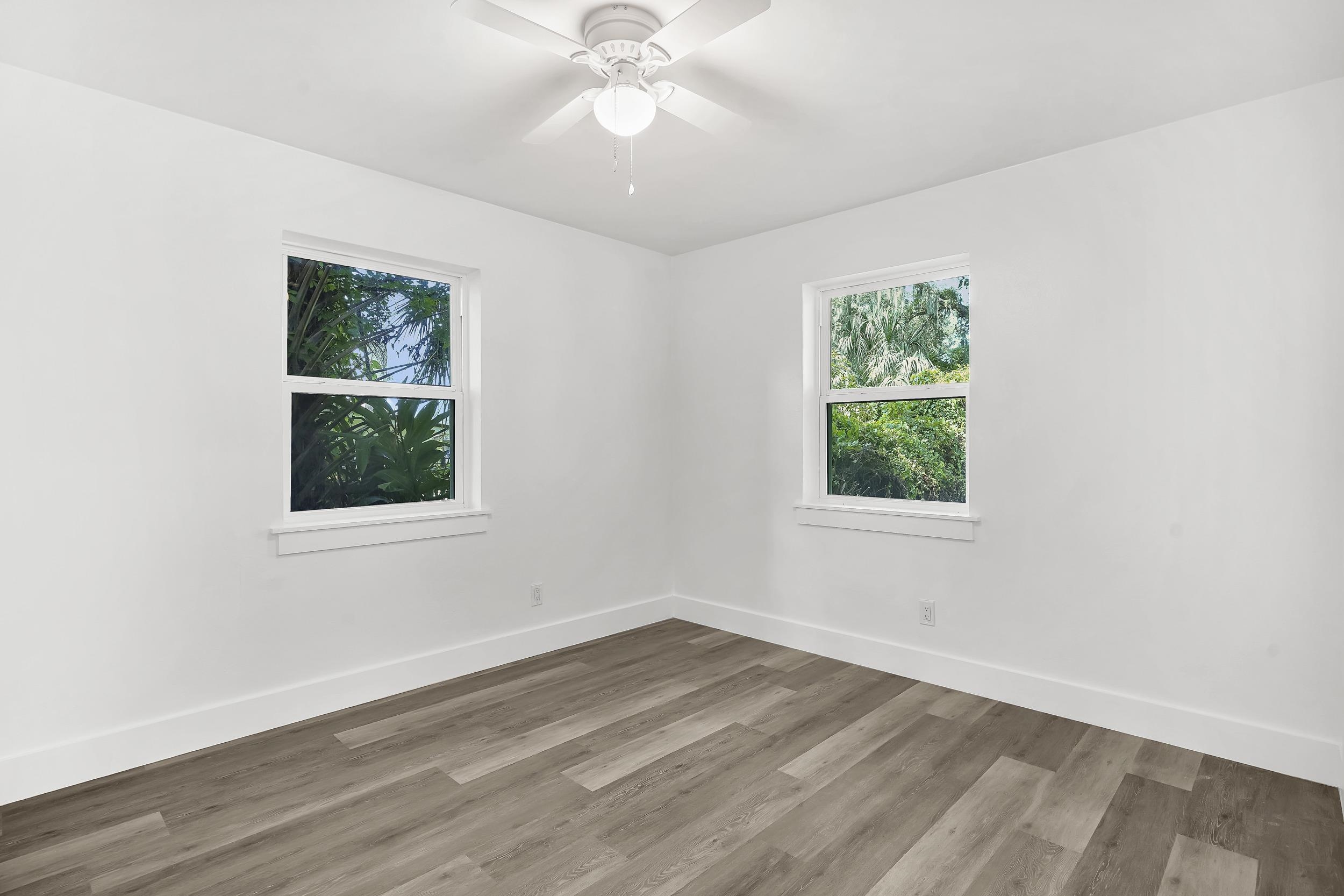 13 Oak Street St. Augustine, FL 32084 - Photo 32 of 39 an empty room with wooden floor and windows