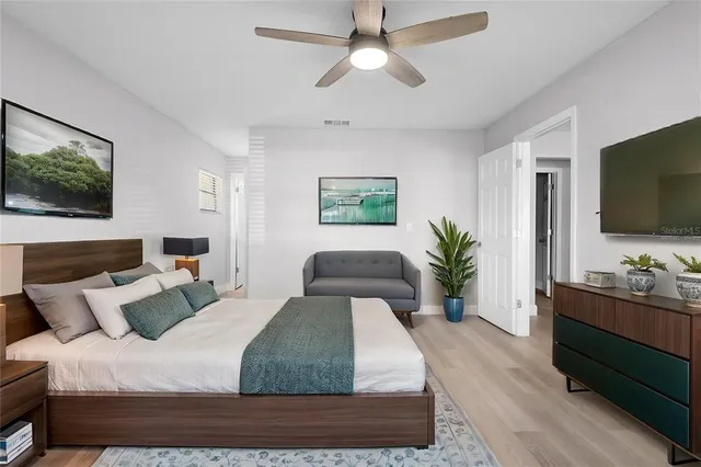 a bedroom with a large bed and a flat screen tv