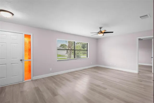 wooden floor in an empty room with a window