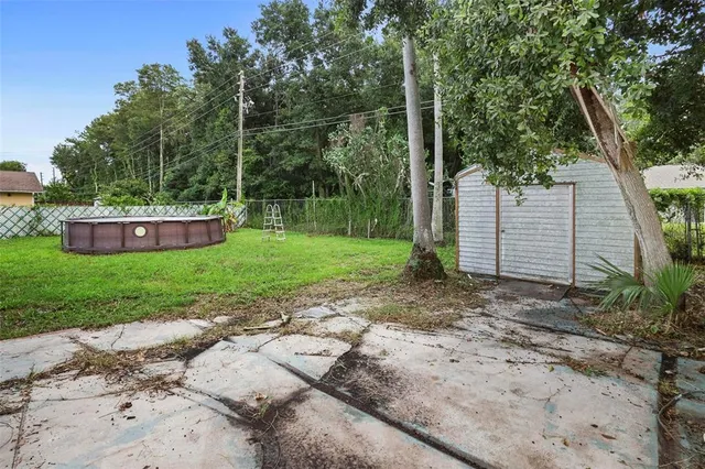 a view of a house with a yard and sitting area