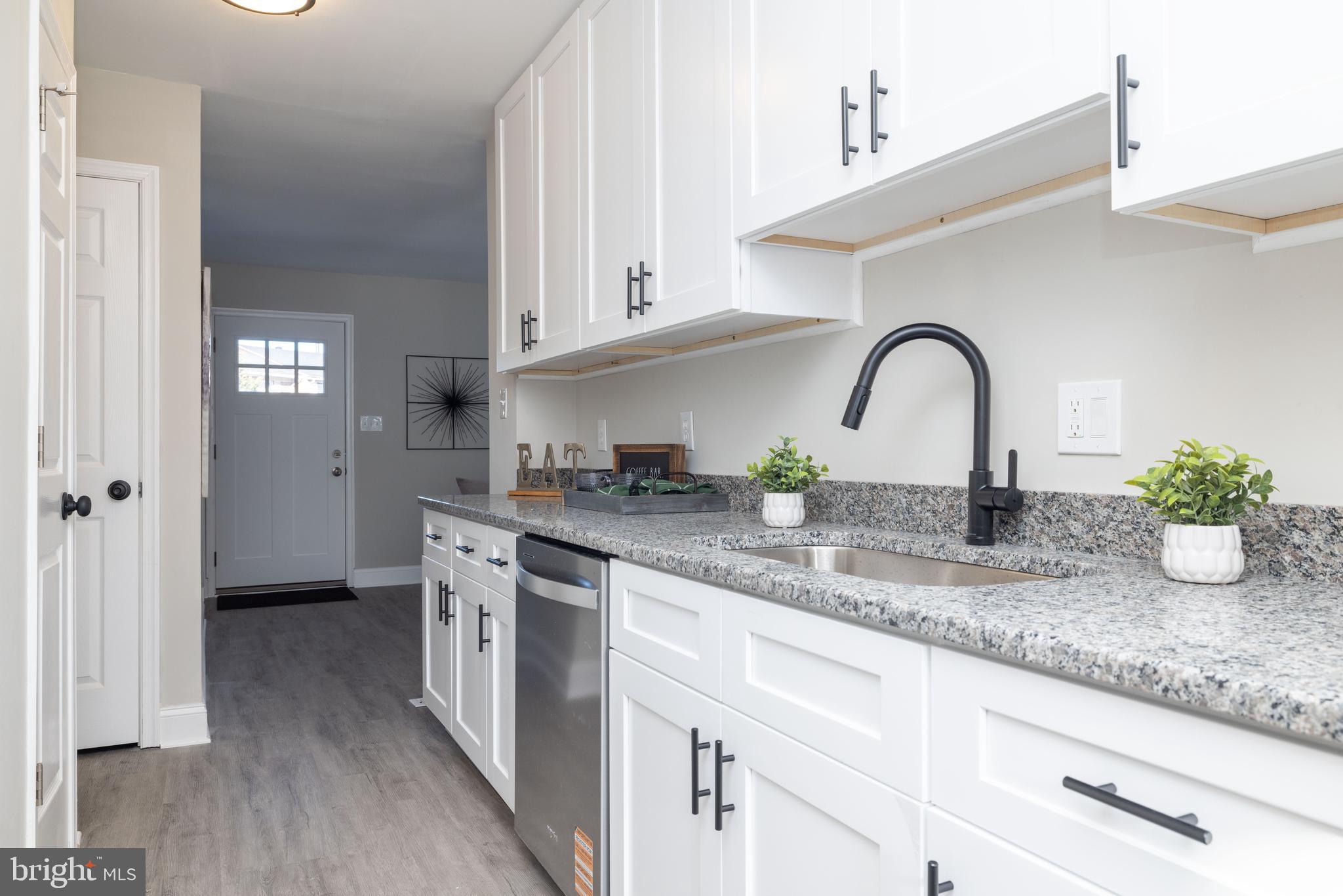 209 West Edgewater Way Newark, DE 19702 - Photo 13 of 34 a kitchen with stainless steel appliances granite countertop a sink and cabinets