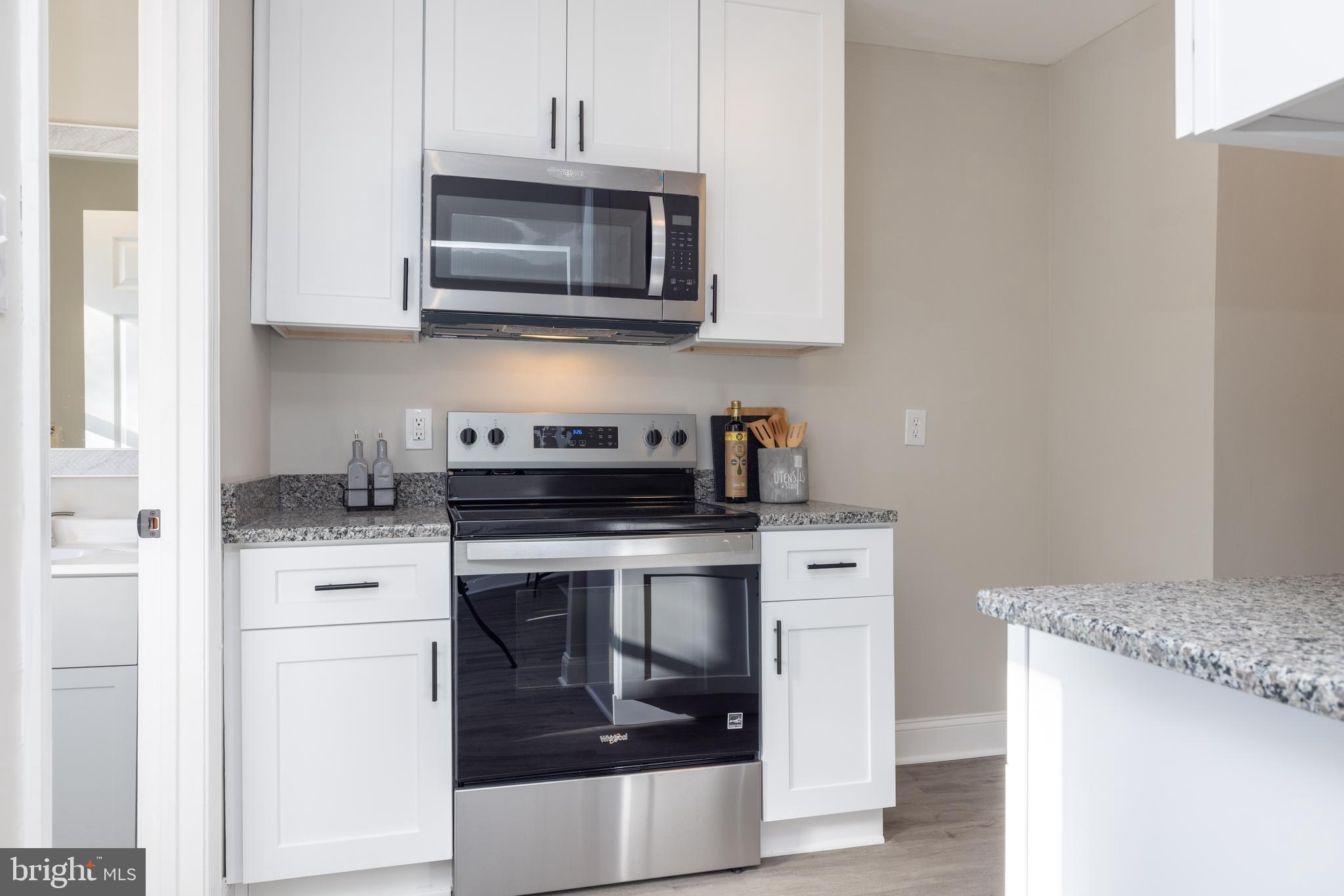 209 West Edgewater Way Newark, DE 19702 - Photo 10 of 34 a kitchen with stainless steel appliances granite countertop a stove microwave and oven