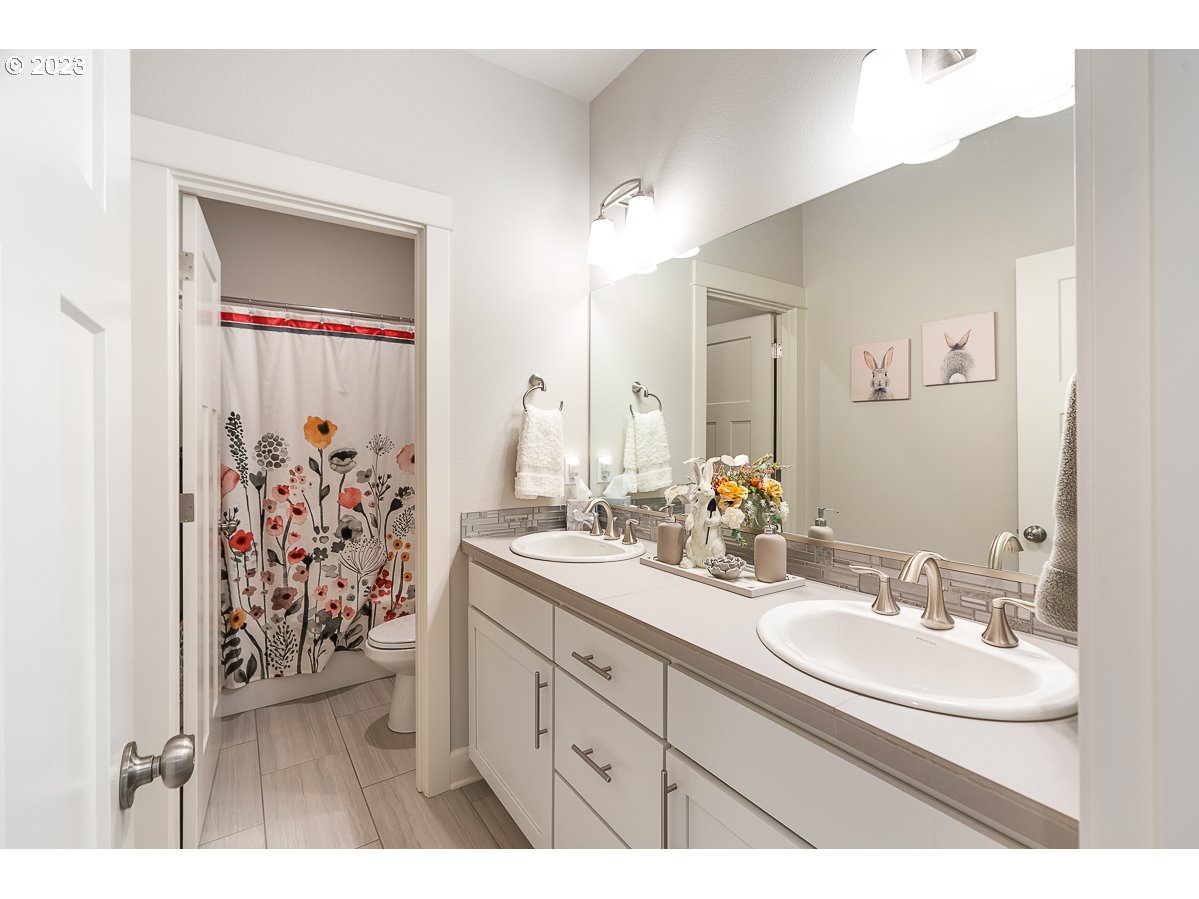 1819 South 50th Place Ridgefield, WA 98642 - Photo 24 of 48 a bathroom with a sink and a mirror