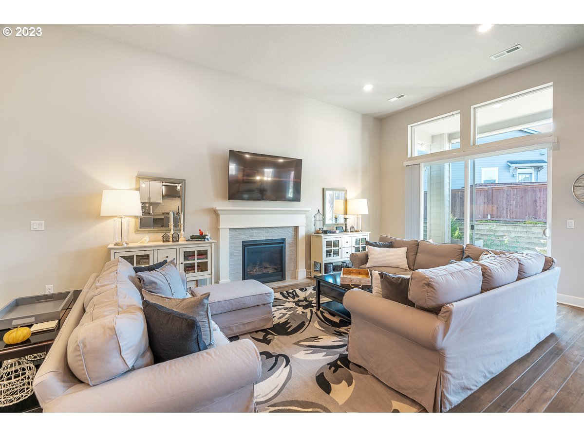 1819 South 50th Place Ridgefield, WA 98642 - Photo 3 of 48 a living room with furniture a fireplace and a flat screen tv