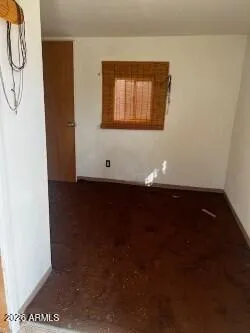 a view of a livingroom with wooden floor and a window