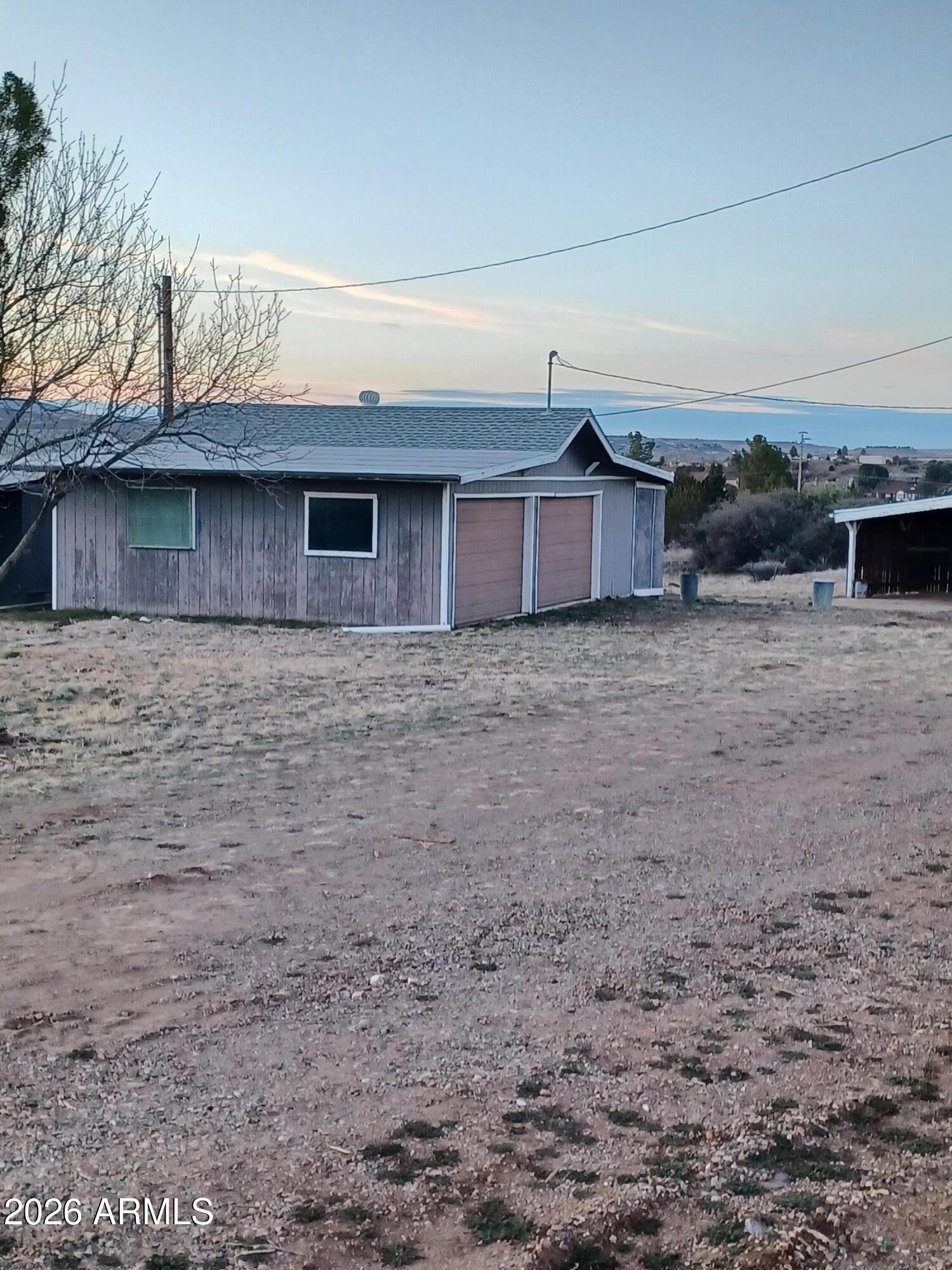 14320 East Bradshaw Road Dewey, AZ 86327 - Photo 3 of 19 a view of a brick house with a yard