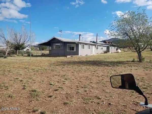 a view of a brick house with a yard