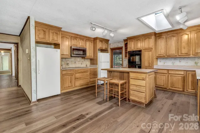 a kitchen with a stove a sink and a refrigerator