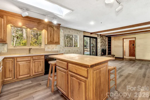 a kitchen with stainless steel appliances granite countertop a refrigerator and cabinets