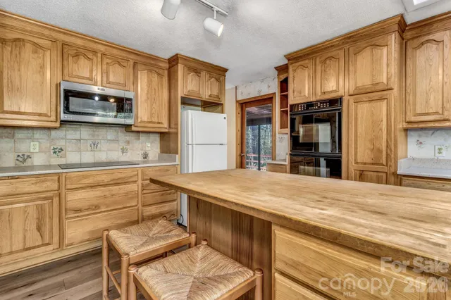 a kitchen with a stove a sink and a microwave