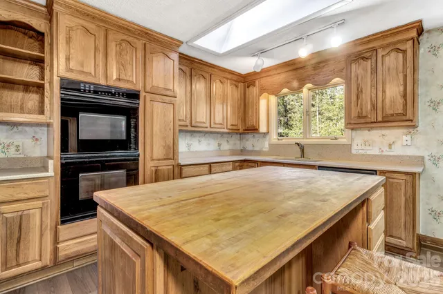 a kitchen with a refrigerator and a stove top oven