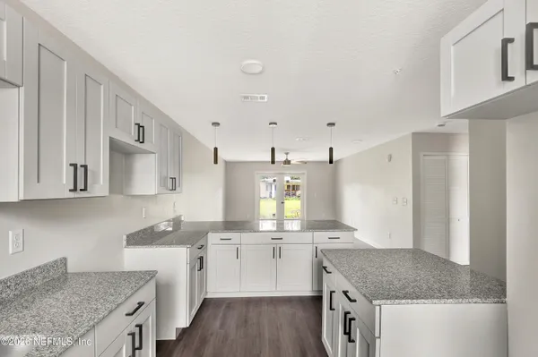a kitchen with a sink stove and cabinets