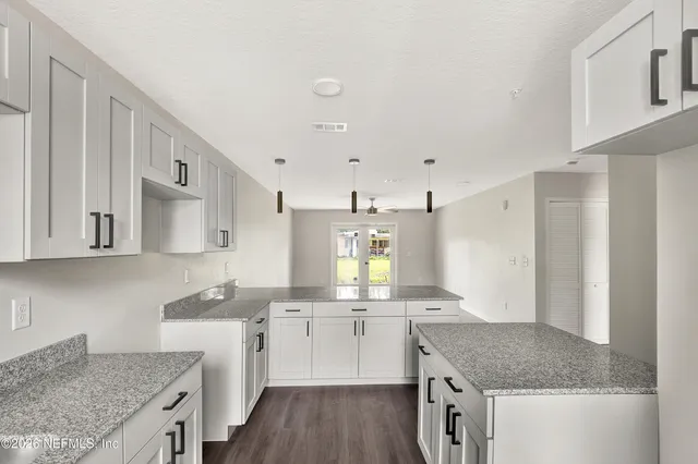 a kitchen with a sink stove and cabinets